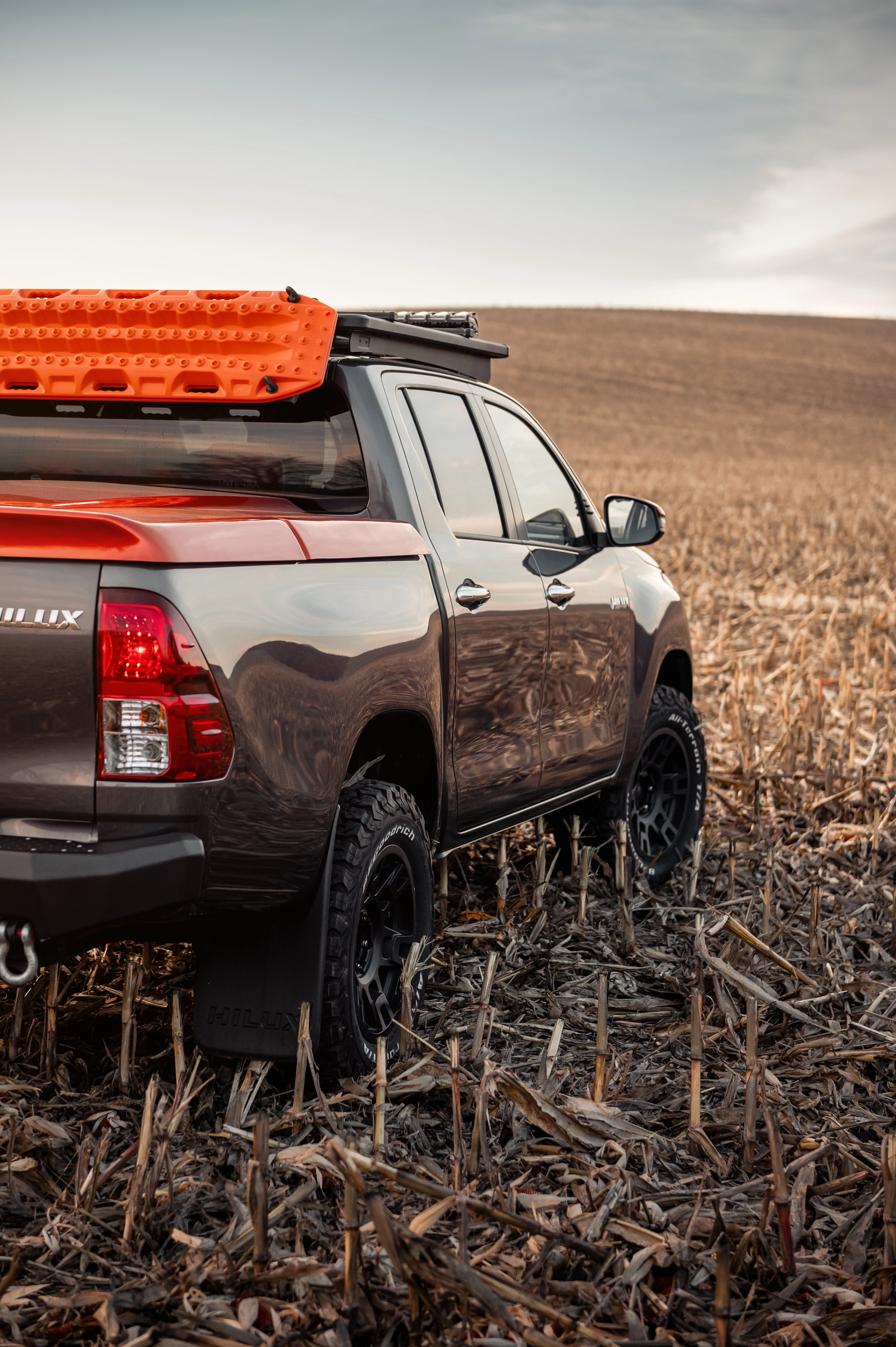 A truck with a tonneau cover in a field. A truck with a tonneau cover in a field.