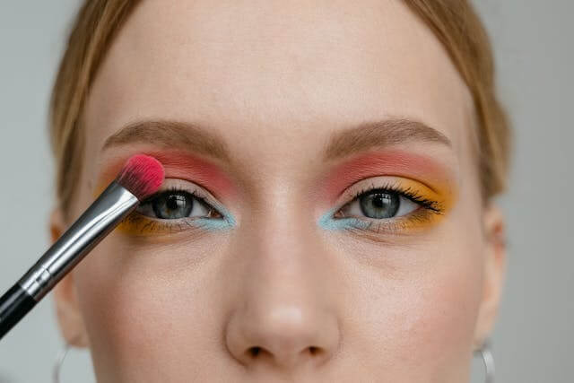 Woman applying paraben-free pigmented eyeshadow