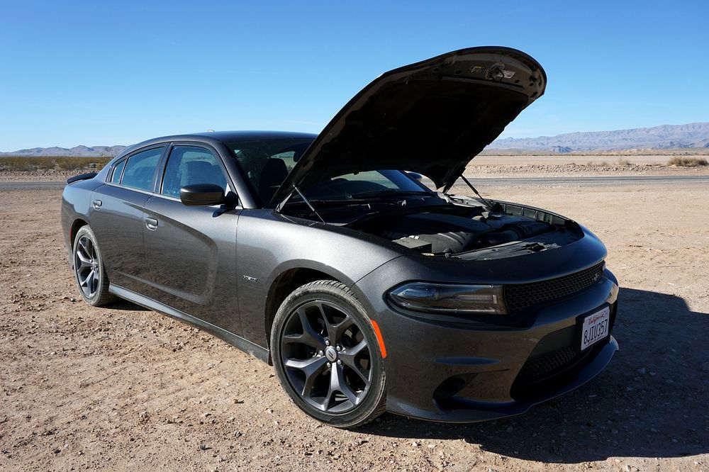 A gray car with an open hood