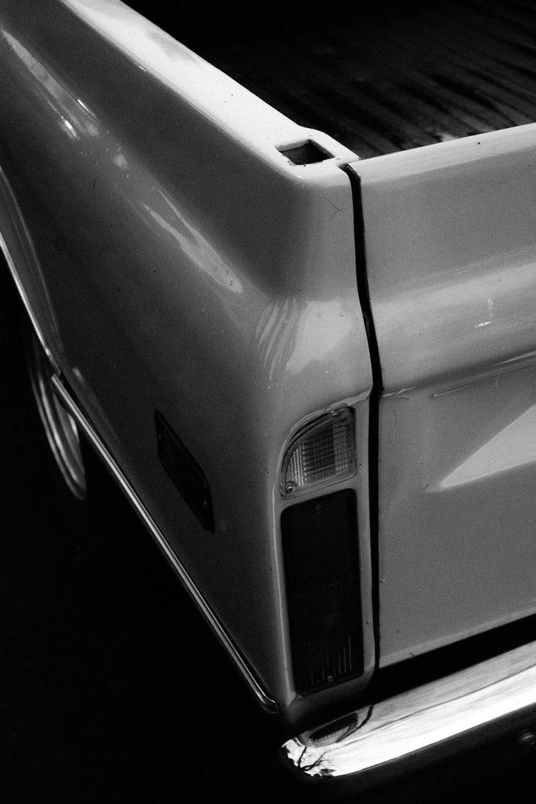 a close-up view of the tailgate of a silver pickup truck