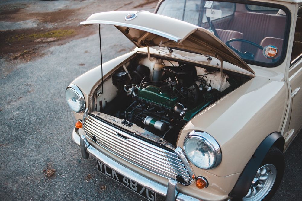 a vintage car with its hood open