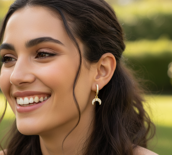 Golden Descending Moon Earrings, a captivating and stylish necklace featuring a textured, crescent moon pendant, crafted in 18K gold-plated stainless steel, and displayed on a model in a casual indoor setting.
