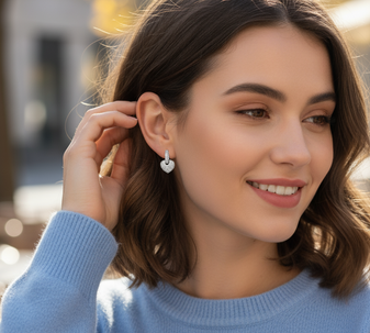a model with Gold Stud Earrings by Hart, a timeless pair of classic gold stud earrings from the elegant Hart collection, crafted in 18K gold-plated stainless steel, and displayed on a white background.