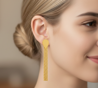 A model wearing Moonlit Threads Earrings, an elegant pair of thread-style earrings designed to create a delicate dangling effect, crafted from 18-karat gold-plated stainless steel and presented against a white background.