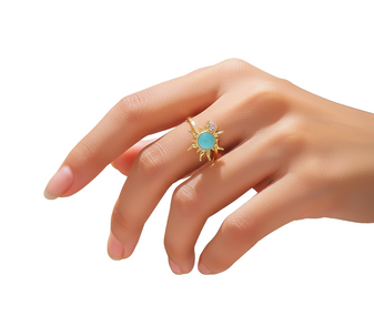 A close-up photo of a young woman's hand, wearing the spinning Aqua Sunflower Ring on her finger. Set on a white background.