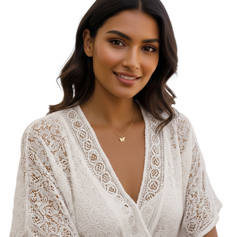 A young woman wearing the Flirty Butterfly necklace complements her summer outfit.