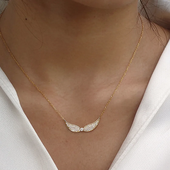 Wings Of An Angel Necklace by Keira K in gold on a model's neck