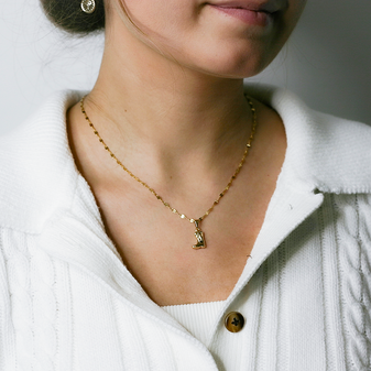 A photo of a young woman wearing the Wild West Boot Necklace by Keira K Jewellery, showcasing its length and intricate details.