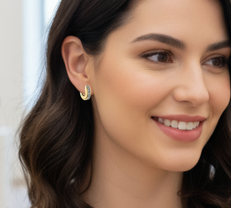 A model wearing elegant Featherlight Dreams hoop earrings in silver, perfect for wearing all day long and showing off minimalist beauty.