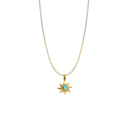 A detailed shot of a round, sunburst-designed pendant featuring a small genuine turquoise gemstone in the centre. The pendant is attached to a delicate 18k gold-plated sterling silver chain.
