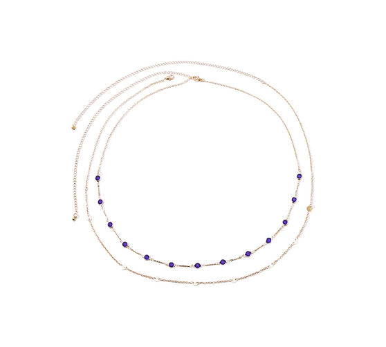 Close-up shot focusing on the deep blue zircon of the Azure Mirage Body Chain on its gold-plated chain.