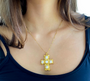 Divine Radiance Cross Necklace. What a cracker! This 18K gold-plated stainless steel cross necklace is a real stunner, featuring sparkling zircon gems that catch the light. As you can see on the model, it's the perfect piece to add a bit of spiritual sparkle to your look.
