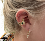 Model wearing the Pretty Butterfly Ear Cuff, showcasing its 18K gold-plated butterfly design with green zircon.
