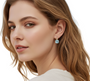A young woman, showcasing a pair of gold-filled aquamarine earrings that add a subtle pop of colour and elegance to her look.