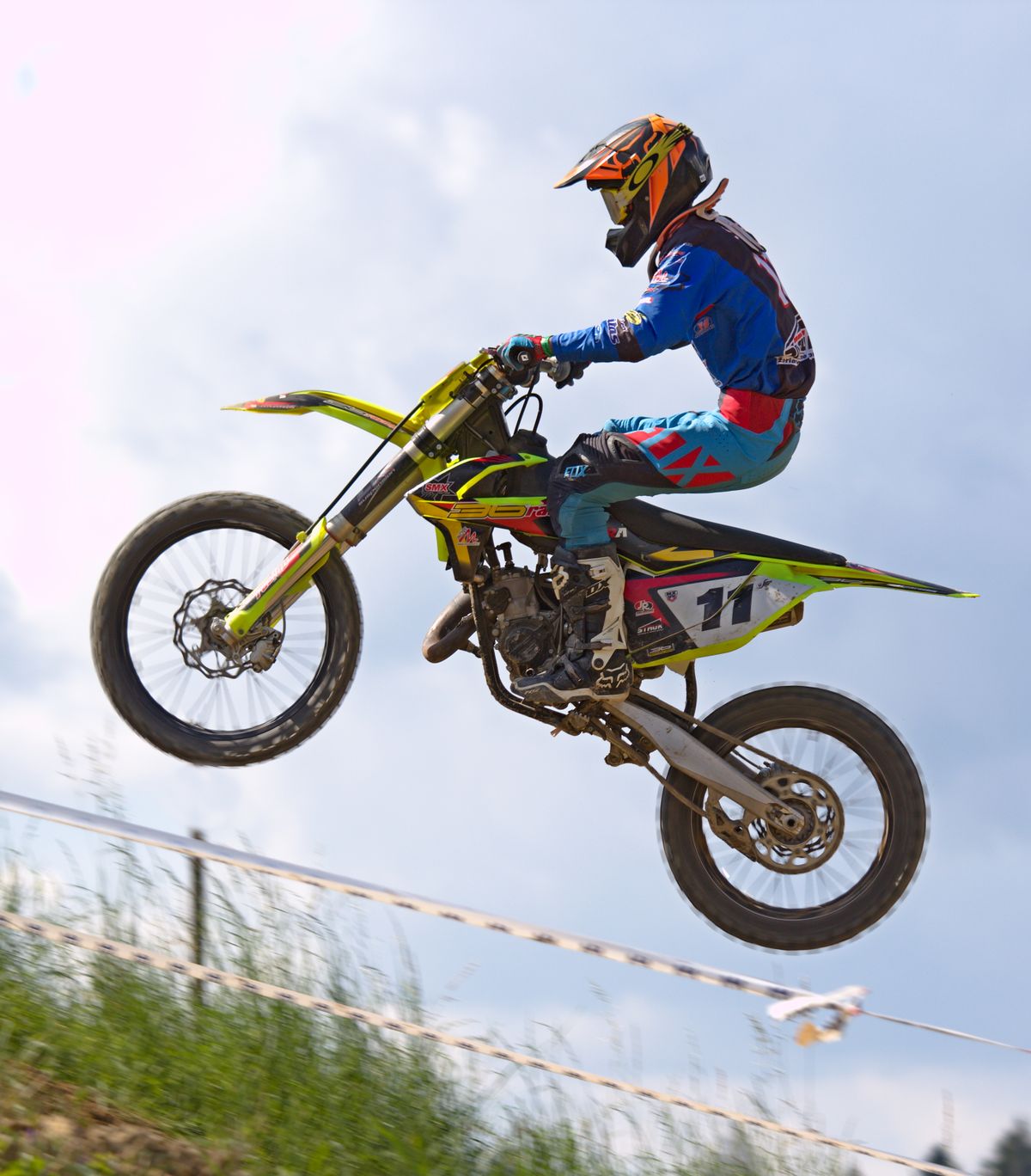 Dirt bike mid-jump on a motocross track