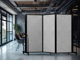 Modern office area with a three-panel wheeled divider featuring light gray panels on a polished concrete floor.