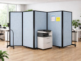 Light blue mobile office partitions enclosing a printer area in an open workspace.