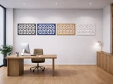 Minimal office with a wood desk, office chair, and four colorful geometric wall panels mounted above.