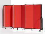 Red folding partition wall with multiple hinged panels on wheels, arranged in a zigzag position against a white background.