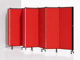 Red folding partition wall with multiple hinged panels on wheels, arranged in a zigzag position against a white background.