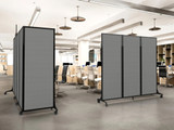 Modern open office with gray rolling partition panels dividing rows of workstations and office chairs.