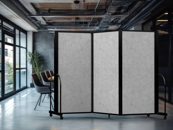 Modern office area with a three-panel wheeled divider featuring light gray panels on a polished concrete floor.