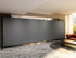 Large gray mobile room divider spanning a lounge area with modern seating and side tables.