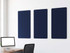 Three navy blue acoustic wall panels mounted above a desk in a modern office.
