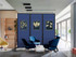 Modern lounge seating area with blue chairs and a wheeled blue divider featuring framed botanical artwork.