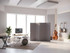 Modern music studio with instruments and a gray freestanding acoustic divider near a drum set.