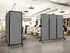 Modern open office with gray rolling partition panels dividing rows of workstations and office chairs.