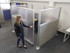 Person opening a frosted sliding door on a gray fabric office cubicle