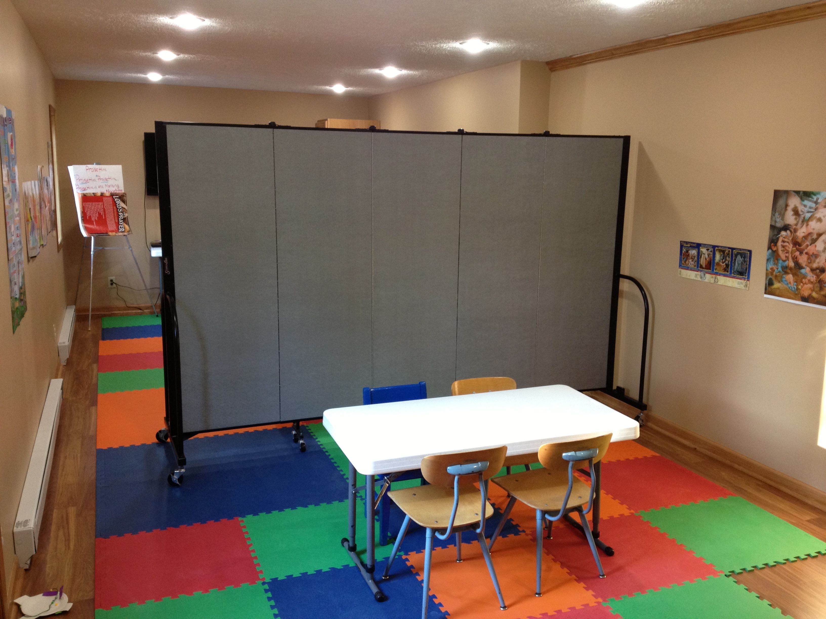 A room divider is opened to separate a room in two Portable classroom walls separate a room in two