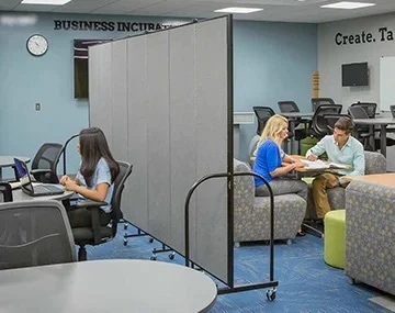 Two Classrooms in One social distancing dividers separating a classroom