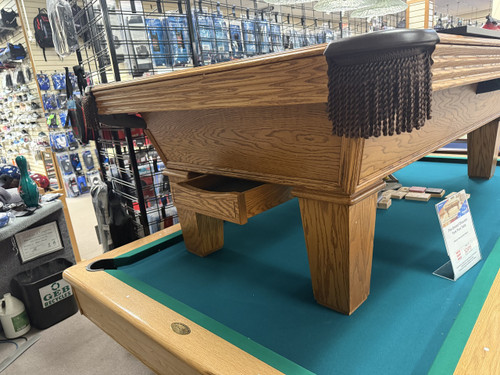 Pre-owned 8 foot Olhausen Classic pool table in American walnut on oak with ball return system and Accu-Fast cushion