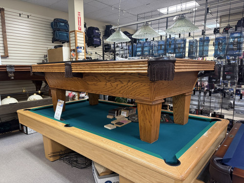 Pre-owned 8 foot Olhausen Classic pool table in American walnut on oak with ball return system and Accu-Fast cushion
