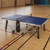 Cornilleau 500 Indoor blue ping pong table set up in a home game room

