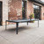 Cornilleau HYPHEN outdoor ping pong table black grey installed in luxury patio, pool deck, or resort setting