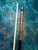 Forearm of Giuli custom cue highlighting brown stained curly maple figure and turquoise ringwork.