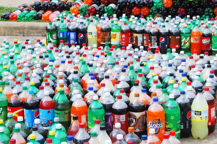 Lots of soda or pop bottles for a school carnival and soda ring toss game!