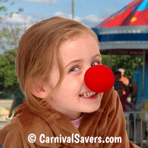 Little girl with clown nose at a carnival