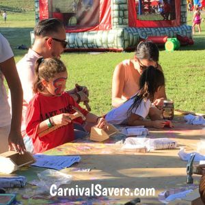 parents-and-children-building-a-wood-craft-at-a-fun-fair-booth.jpg
