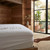 white-waterproof-terry-towelling-mattress-protector-fitted-on-bed-showing-soft-absorbent-fabric-and-low-noise-backing