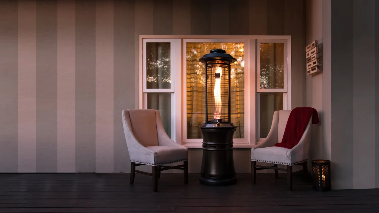 The Axis glass tube heater lit on a home patio at dusk