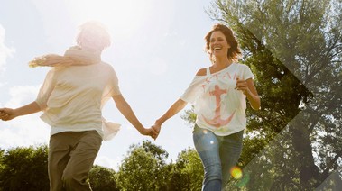 Two young lady holding hand together running in the field
