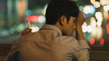 Tired man holding a cigarette