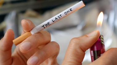 A person lighting the last cigarette