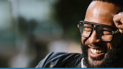 Man with glasses smiling