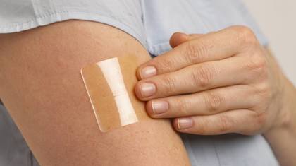 A woman wearing patch on arm