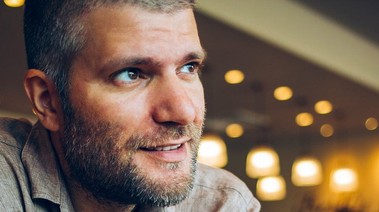 A man sitting with a little smile on his face